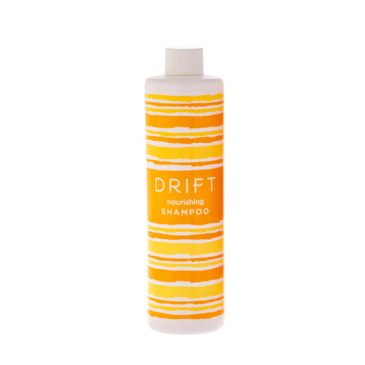 DRIFT 12oz Shampoo bottle offering a refreshing and nourishing cleanse for hair in hotel guestrooms.